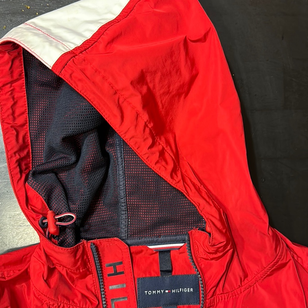 Red Tommy Hilfiger raincoat. Medium size but it kinda fits like small